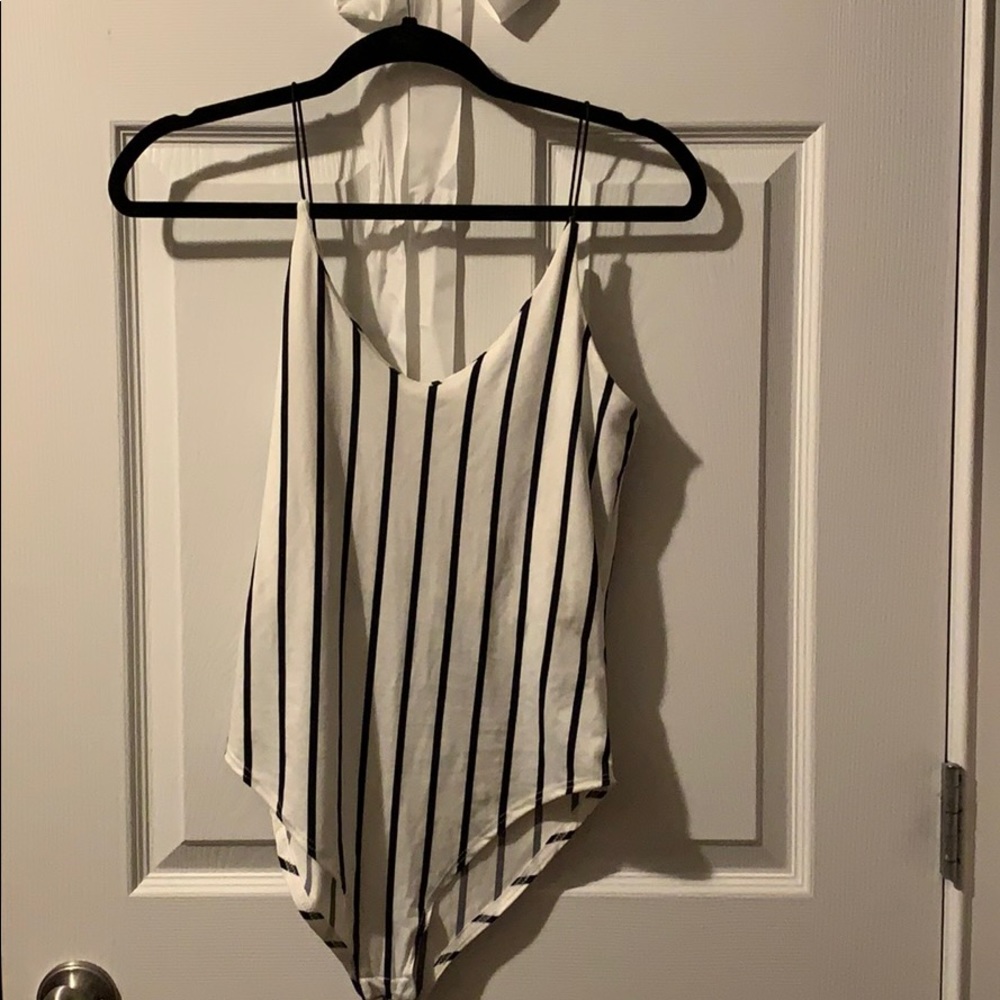 This strapped body suite white with black stripes